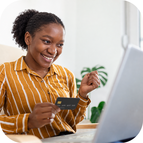 Woman in yellow top holding phone and debit card